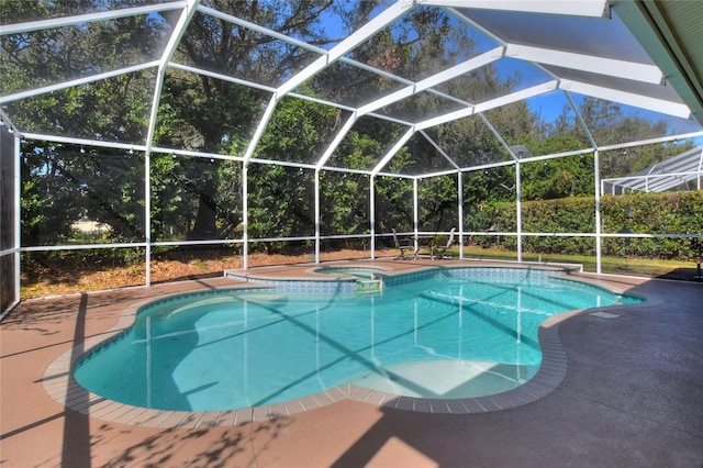 view of pool featuring an in ground hot tub, a patio, and glass enclosure