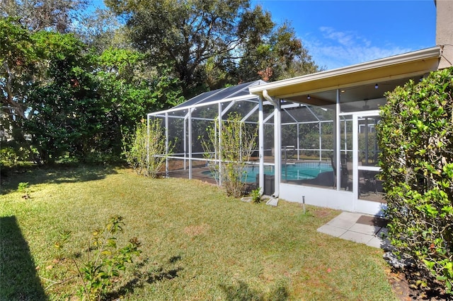 view of yard with glass enclosure