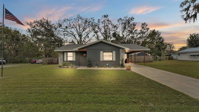 view of front facade with a carport and a lawn