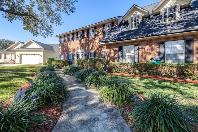 view of front of property featuring a front yard and a garage