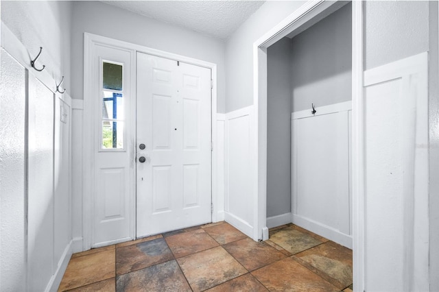 foyer with a textured ceiling