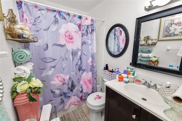 bathroom with vanity, a shower with shower curtain, and toilet