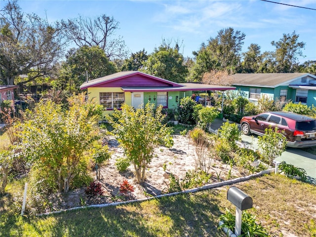 ranch-style house featuring a carport