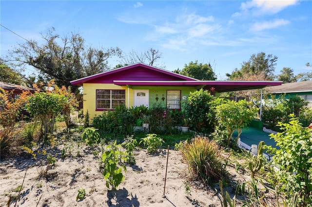 single story home featuring a carport