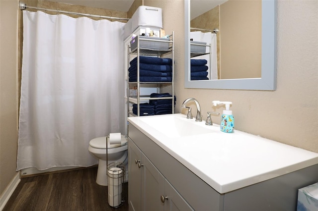 bathroom with hardwood / wood-style floors, vanity, toilet, and a shower with curtain