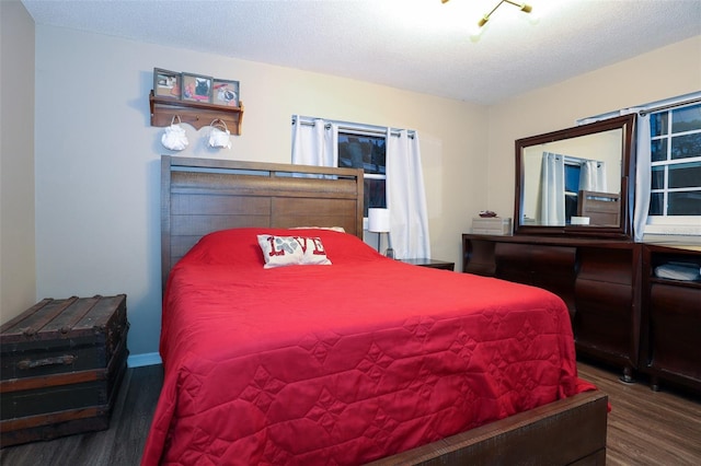 bedroom with wood-type flooring and a textured ceiling