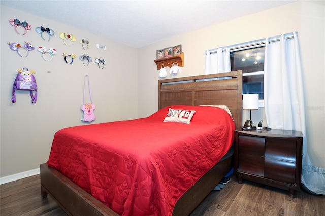 bedroom with hardwood / wood-style floors and a textured ceiling