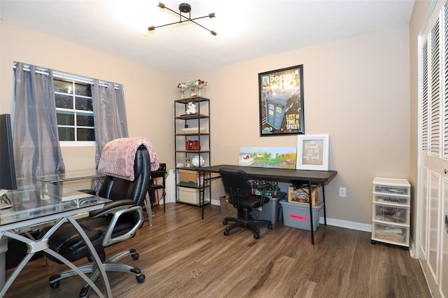 office space featuring dark wood-type flooring and a chandelier