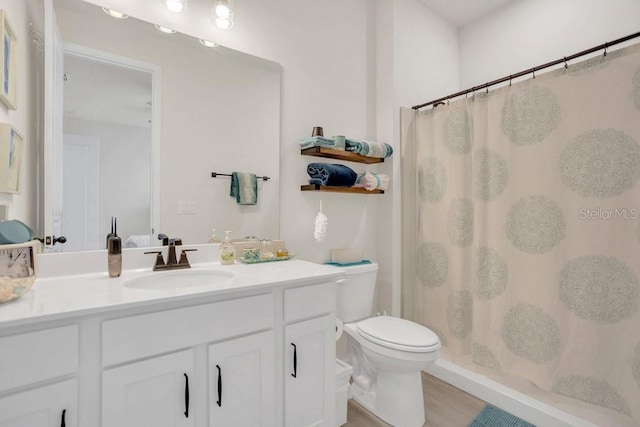 bathroom with toilet, a shower with shower curtain, hardwood / wood-style flooring, and vanity