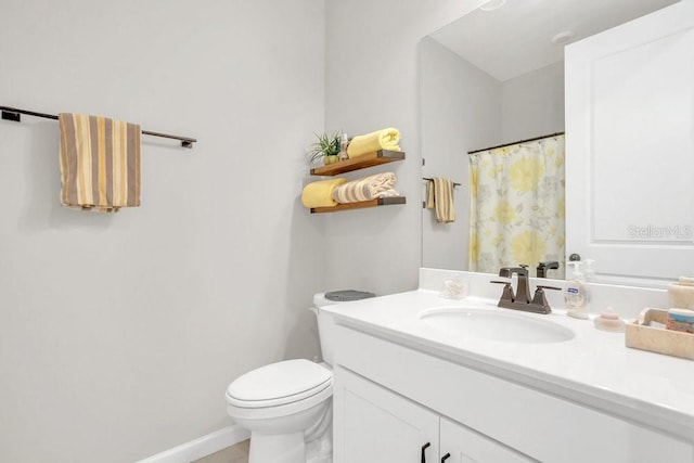 bathroom featuring toilet and vanity