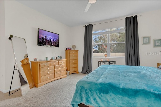 bedroom featuring light carpet and ceiling fan