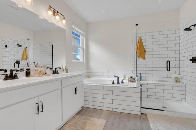 bathroom featuring vanity and shower with separate bathtub