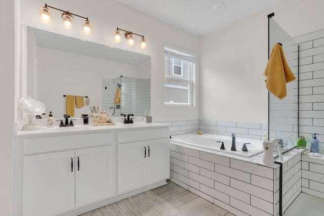 bathroom featuring vanity and shower with separate bathtub