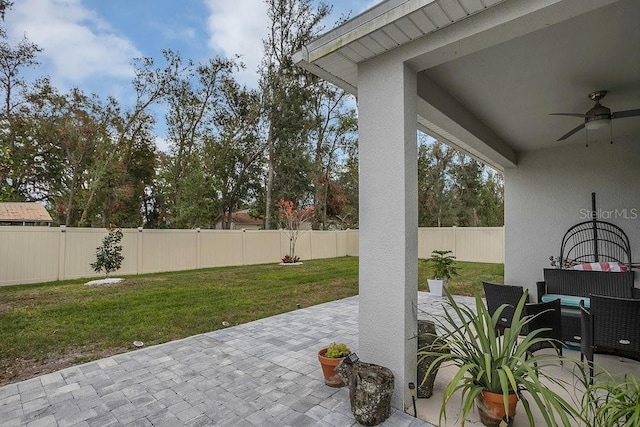 view of patio featuring ceiling fan