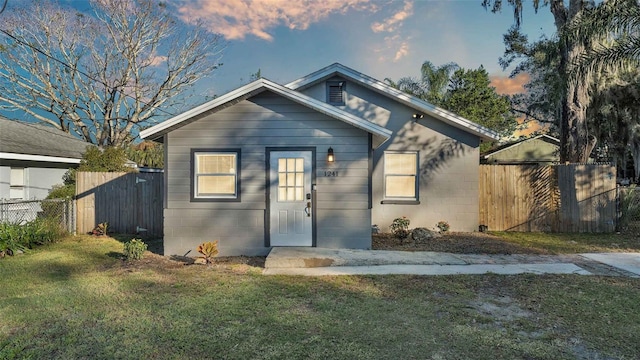 bungalow-style house with a lawn