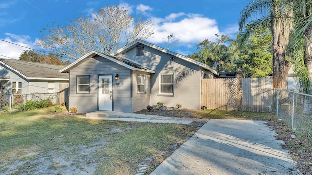 bungalow-style house with a front yard