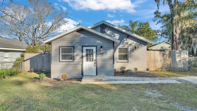 bungalow-style house with a front lawn