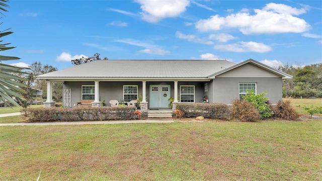 ranch-style house featuring a porch and a front yard