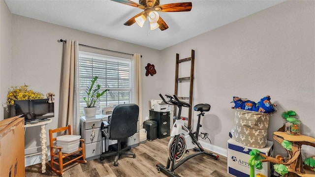 office featuring light wood-type flooring and ceiling fan