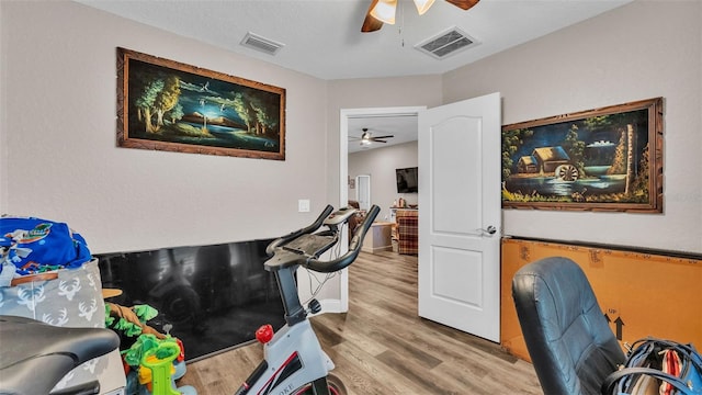 home office with wood-type flooring and ceiling fan