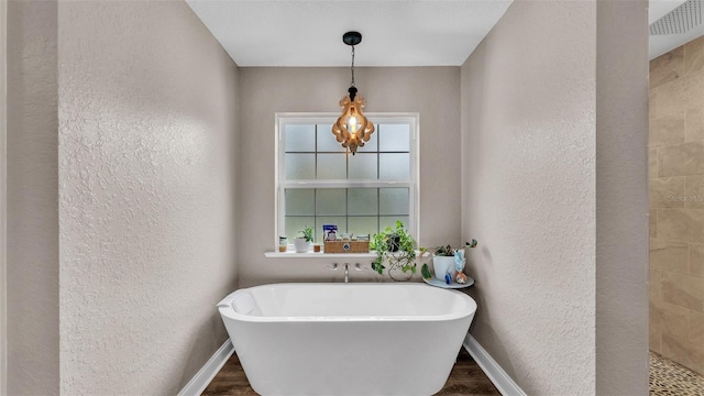 bathroom with hardwood / wood-style floors and a bathtub