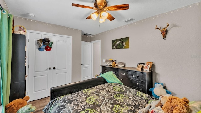 bedroom with wood-type flooring, a closet, and ceiling fan