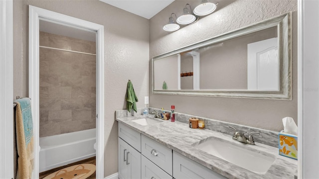 bathroom with vanity and tiled shower / bath combo