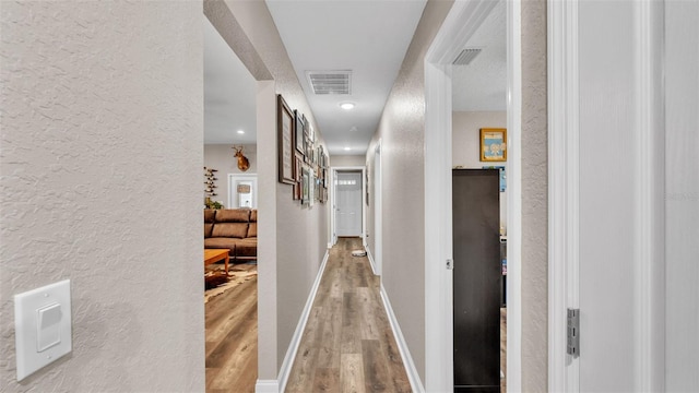 hallway featuring wood-type flooring