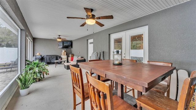 dining room with ceiling fan and french doors