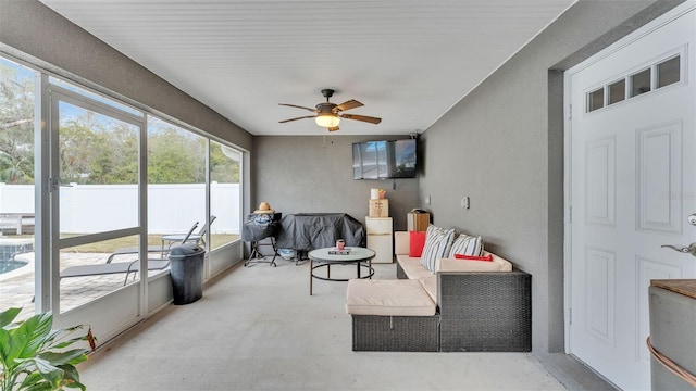 sunroom / solarium featuring plenty of natural light and ceiling fan