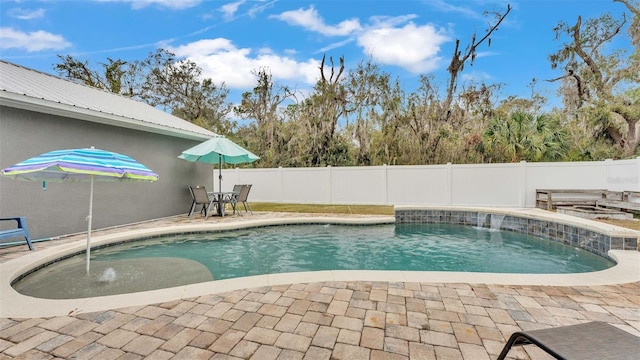 view of pool with pool water feature and a patio