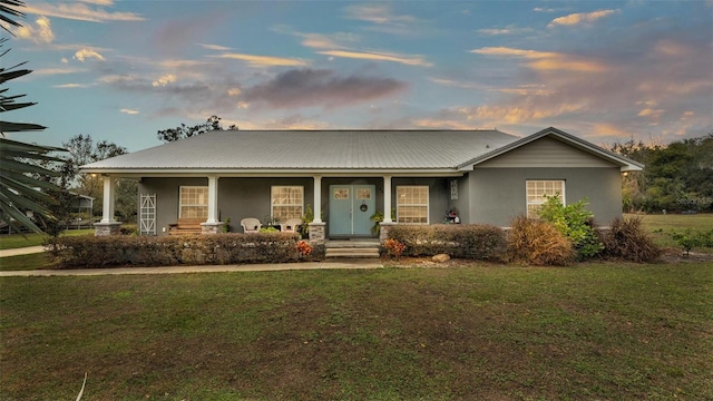 view of front of house with a lawn and covered porch