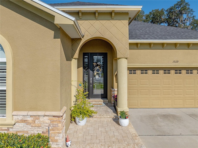 view of exterior entry with a garage