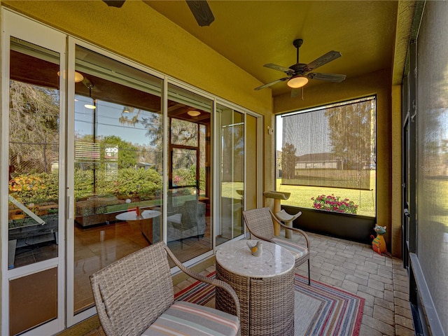 sunroom / solarium with ceiling fan and vaulted ceiling