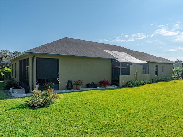 back of house with a lawn