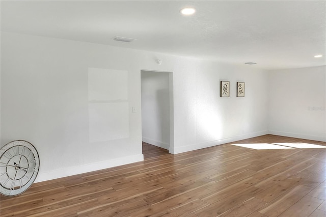 empty room with hardwood / wood-style floors