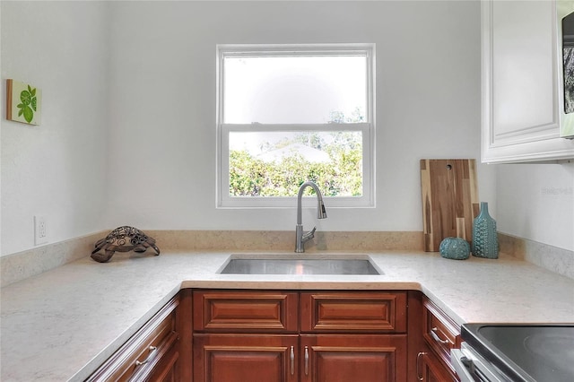 kitchen featuring stove and sink