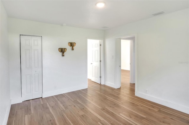 unfurnished room with light hardwood / wood-style floors