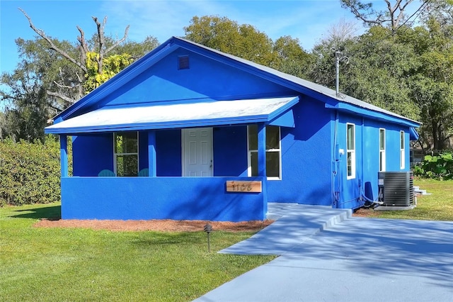 view of front facade with central air condition unit and a front yard