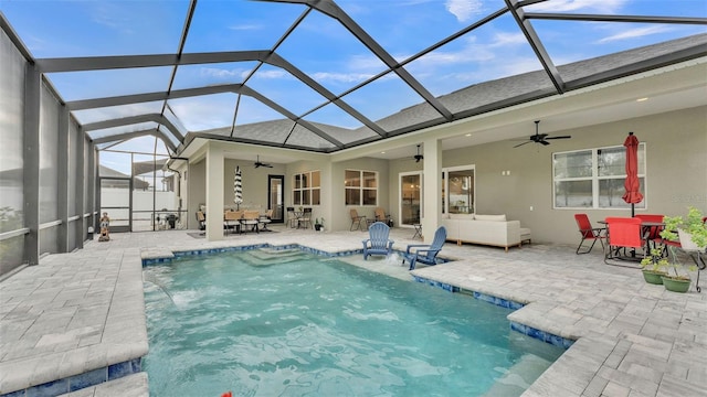 view of pool with a lanai, a patio, ceiling fan, and an outdoor living space