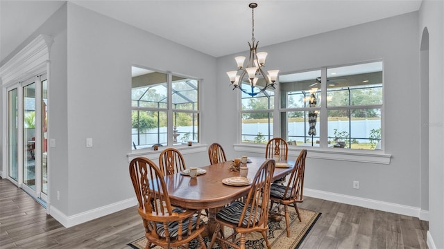 dining room with an inviting chandelier, french doors, and dark hardwood / wood-style floors