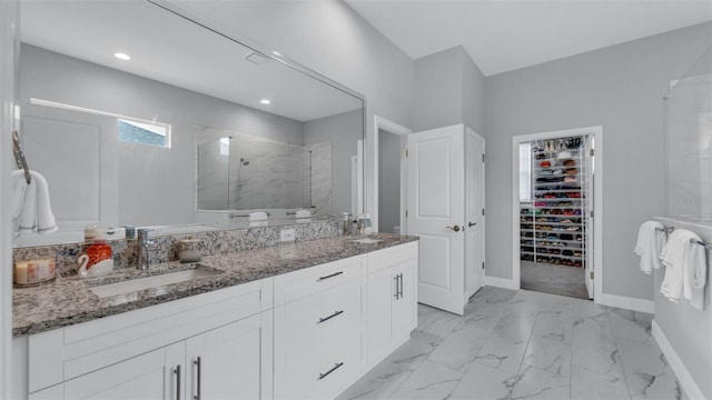 bathroom with an enclosed shower and vanity