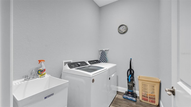 laundry room with sink, dark wood-type flooring, and washer and dryer