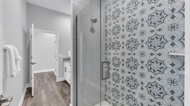 bathroom with vanity, hardwood / wood-style flooring, and walk in shower