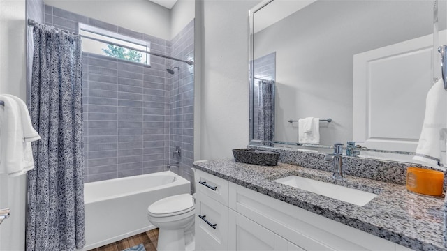 full bathroom featuring shower / bathtub combination with curtain, hardwood / wood-style flooring, vanity, and toilet