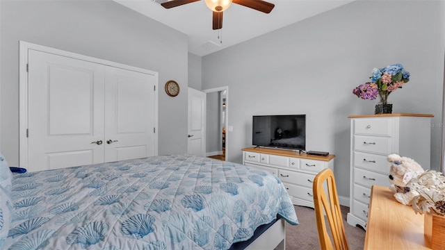 carpeted bedroom with ceiling fan and a closet