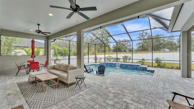 view of swimming pool with outdoor lounge area, ceiling fan, glass enclosure, and a patio