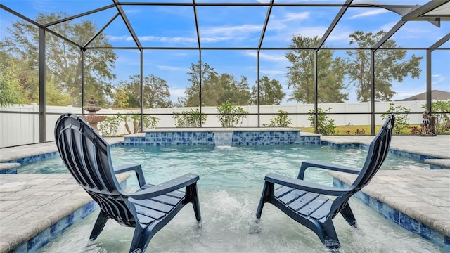 view of pool featuring pool water feature, glass enclosure, and a patio