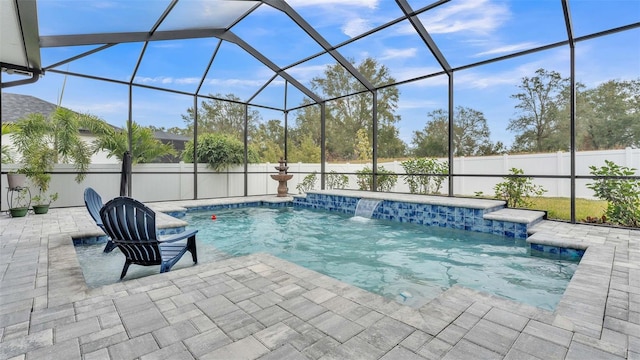 view of swimming pool featuring a patio, pool water feature, and glass enclosure