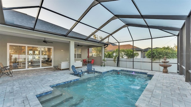 view of swimming pool featuring ceiling fan, a lanai, a patio, and pool water feature